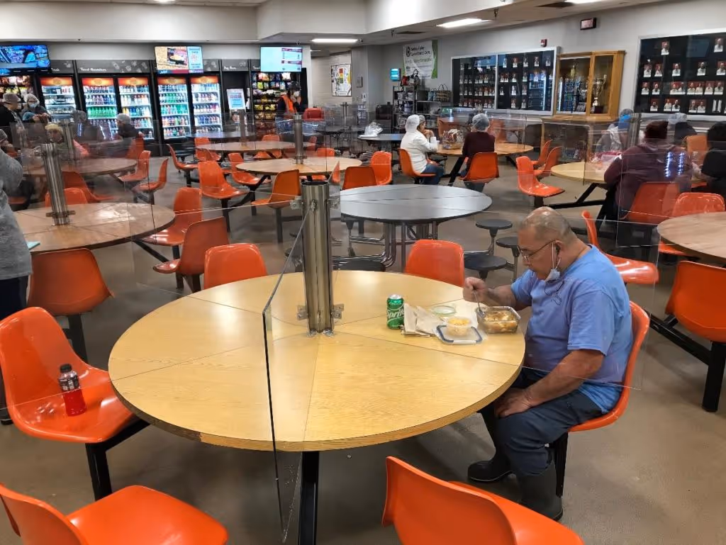 Person sitting at table divided by acrylic